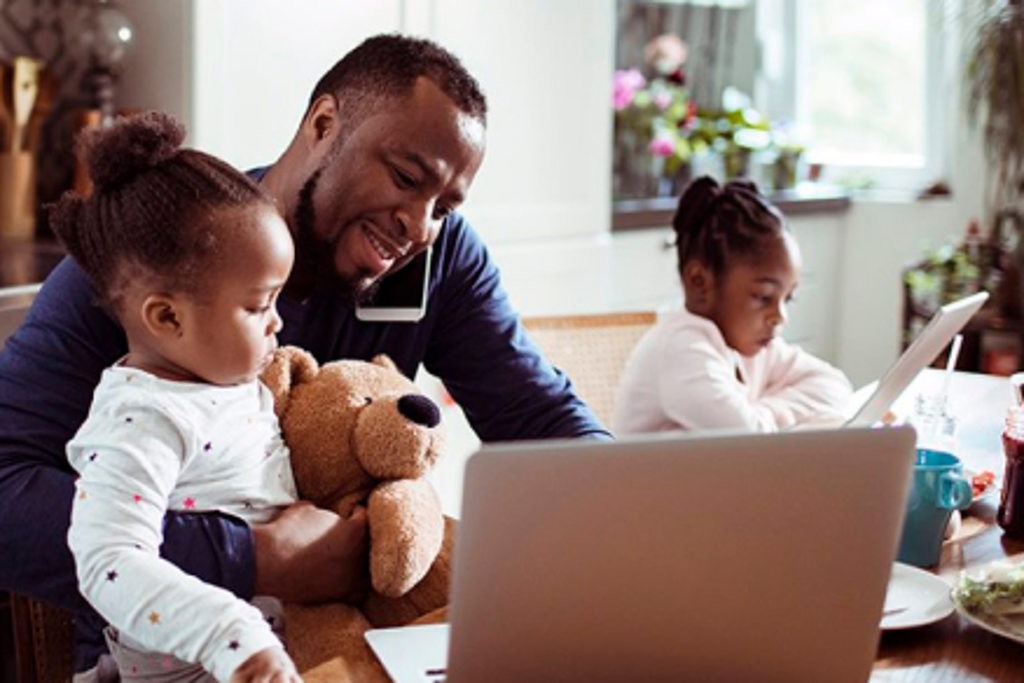 dad and young girls on laptop talking on phone