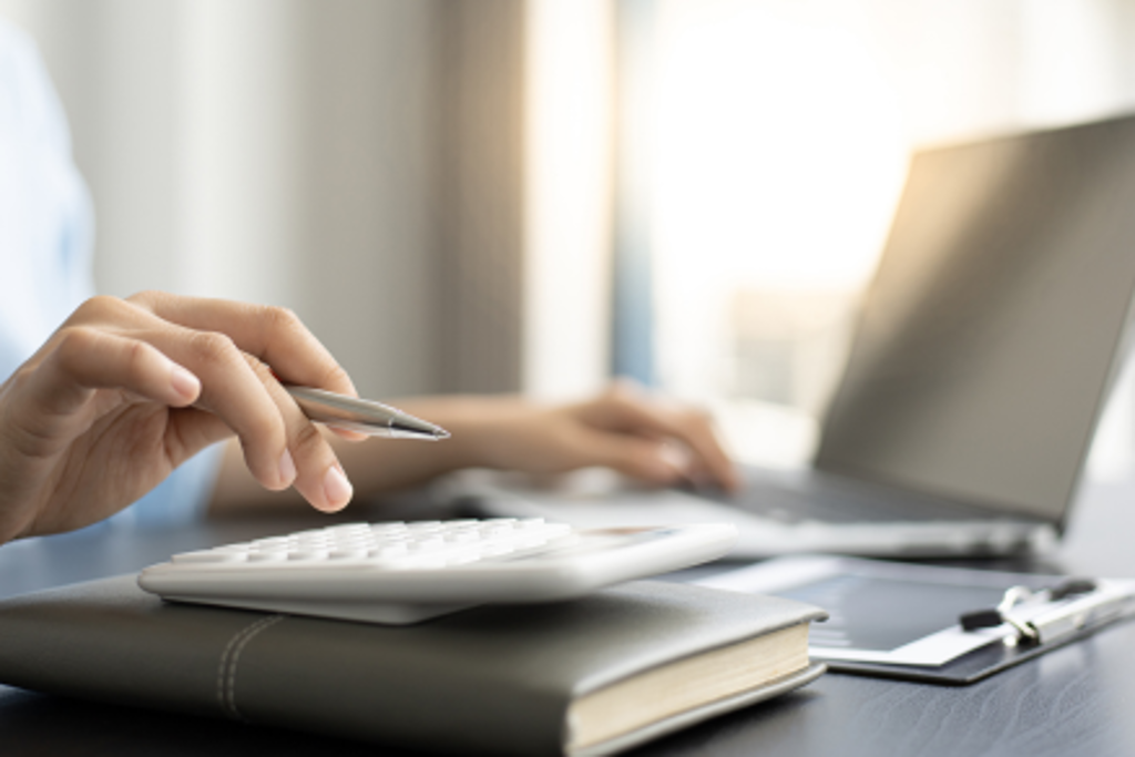 man at computer and calculator